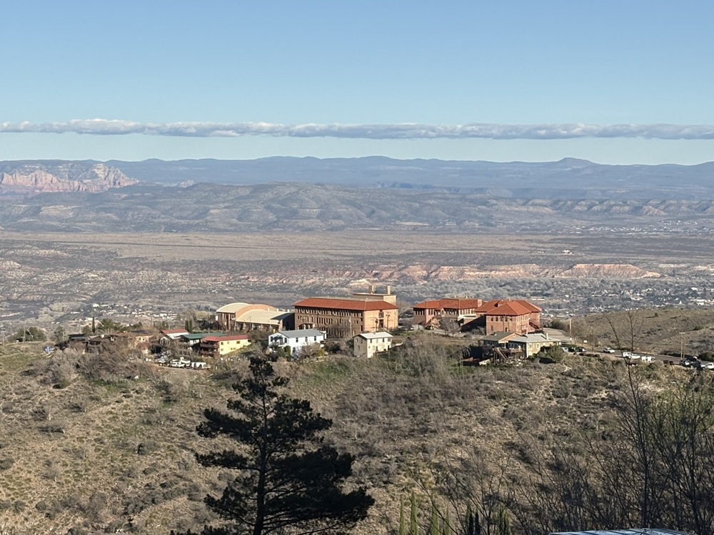 Craig Spiesman image featuring a wide valley with hilltop buildings and layered mountains
