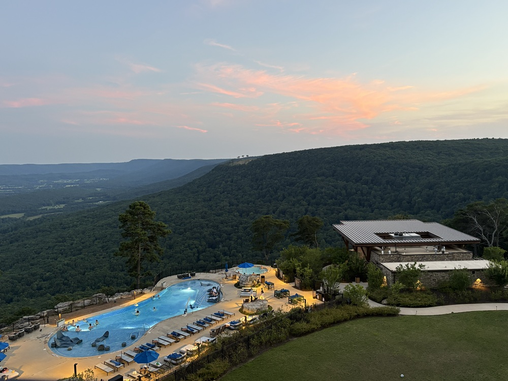 Craig Spiesman image with a swimming pool, lounge chairs, and wooded mountain views
